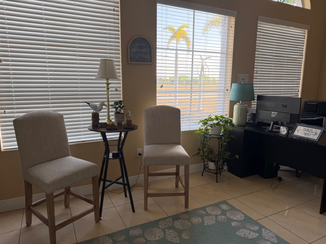 Sunlit reception area with natural light and coastal decor