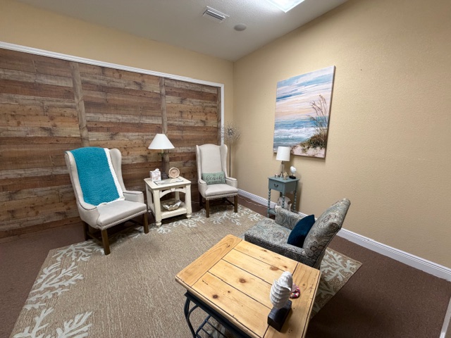 Beach-themed room with reclaimed wood wall and ocean painting
