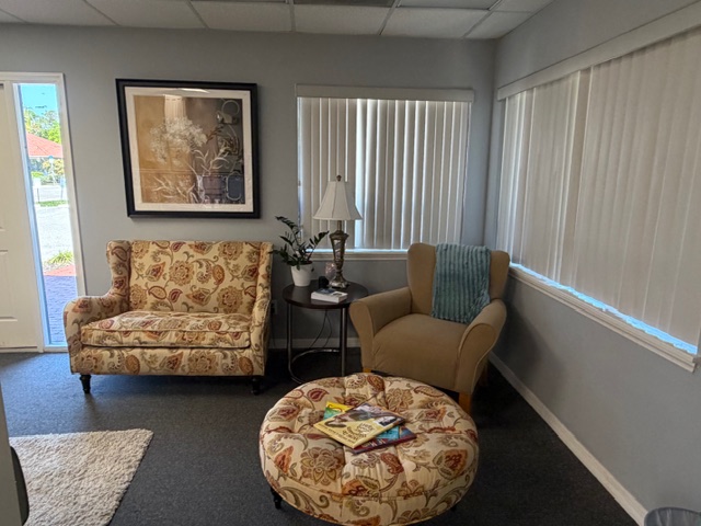 Cozy waiting area with floral loveseat and matching ottoman