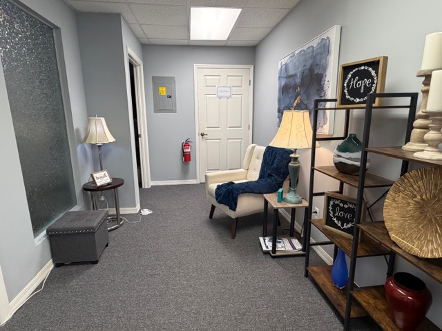 Serene hallway with armchair, abstract art, and Hope sign